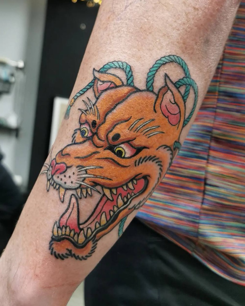 Orange cat-dragon with blue horns