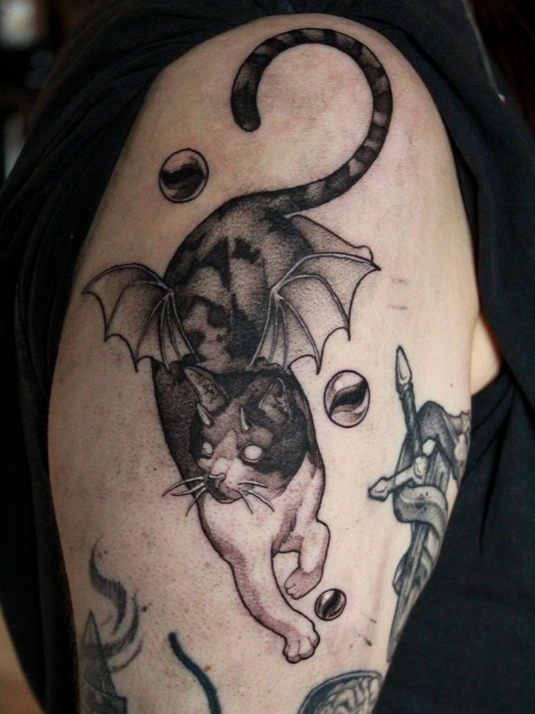 Winged cat with a curling tail