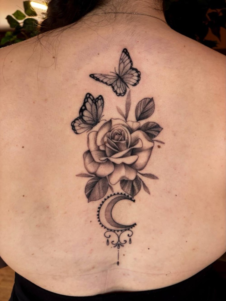 Rose, butterflies and moon down a spine