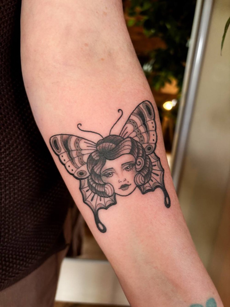 Woman's face inside a butterfly